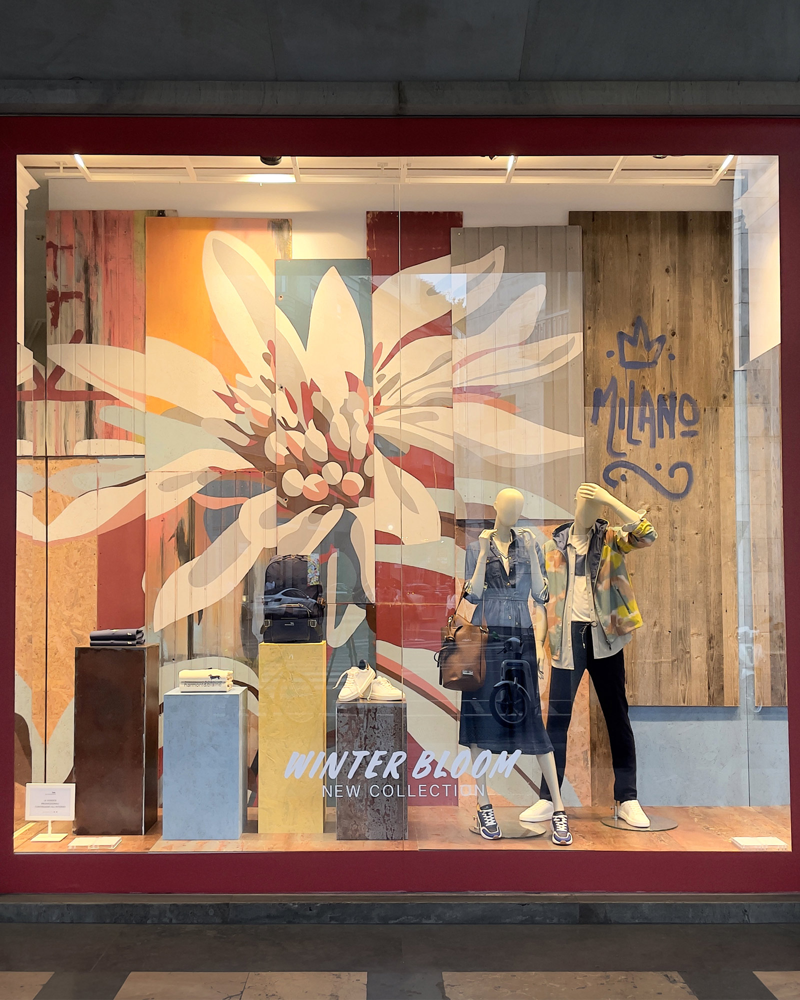 Harmont & Blaine FW25 window with abstract floral details in warm tones.