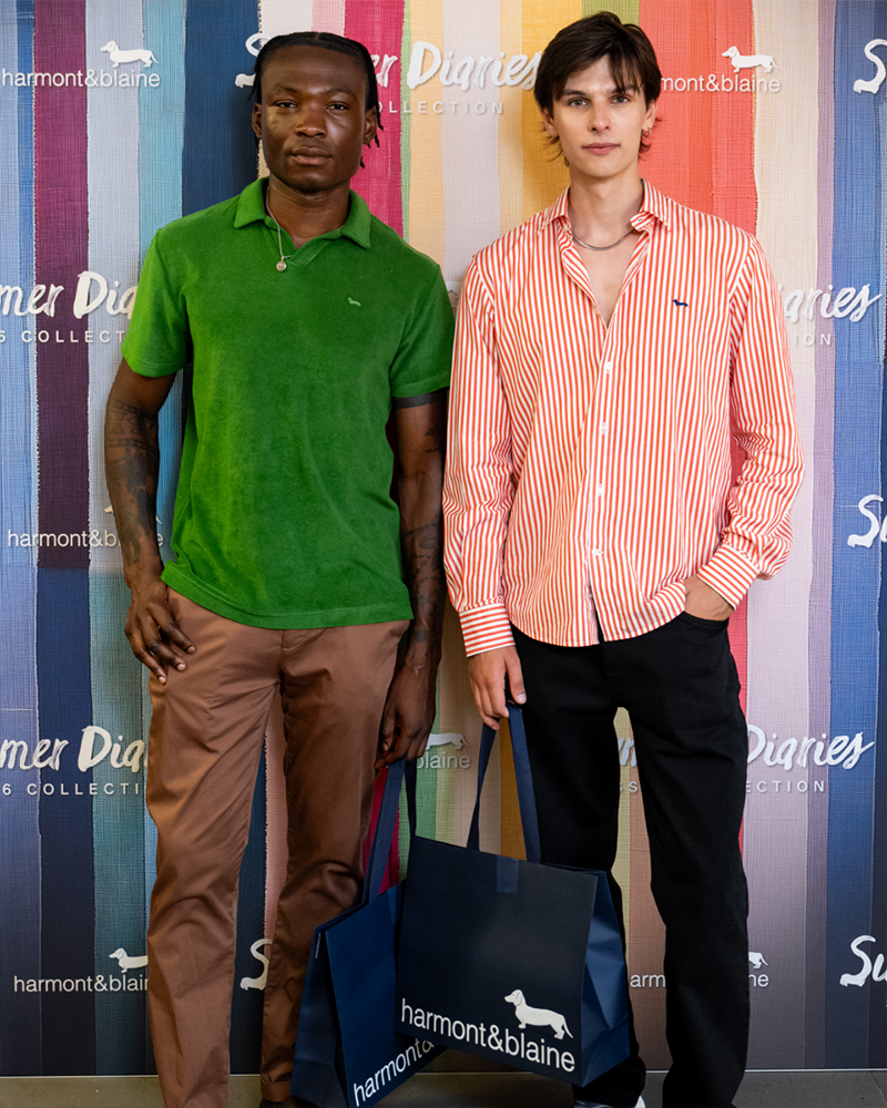 Two men with shopping bags at Summer Diaries event.